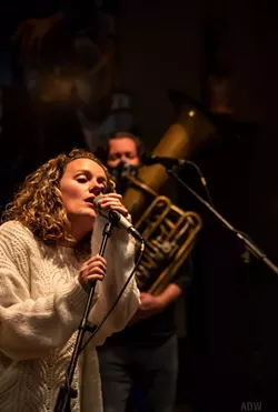 Teagan Ward (foreground) leads Teagan and the Tweeds in a live performance at Three Heads Brewing. - PHOTO BY AARON WINTERS