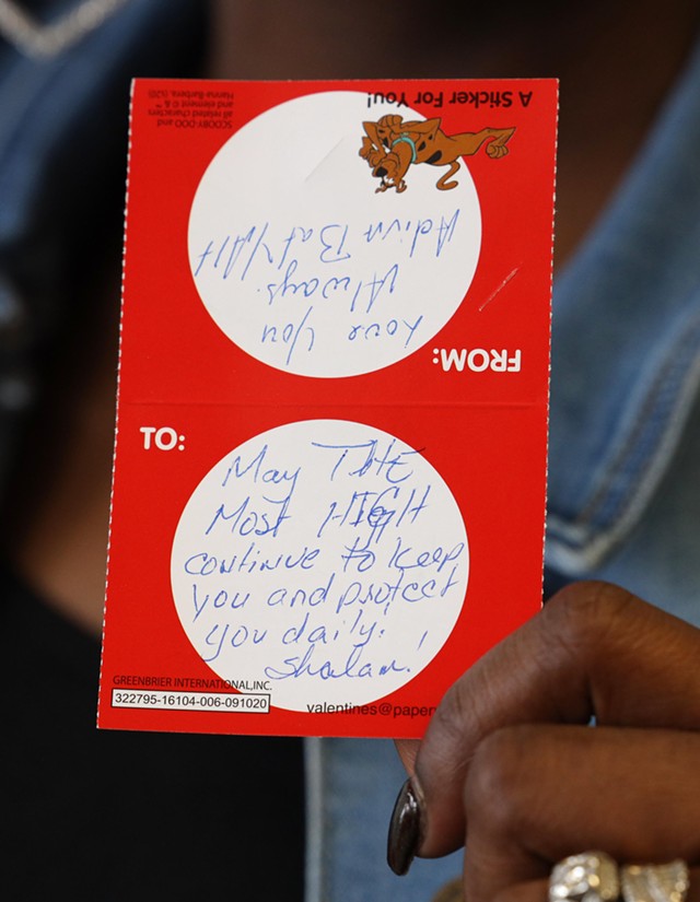Fullilove holds up a valentine addressed to the young girl. The note reads: "May the Most High continue to keep you and protect you daily. Shalom!" - PHOTO BY MAX SCHULTE / WXXI NEWS