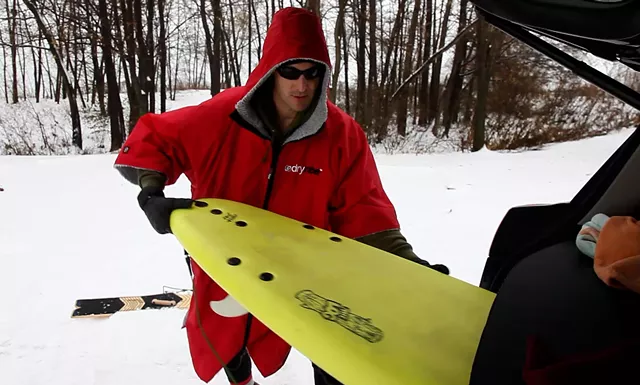 Aurelien Bouche Pillon suits up for a winter surf on Lake Ontario. - PHOTO BY MAX SCHULTE / WXXI NEWS