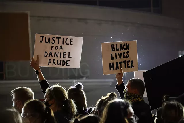 Protesters display signs at one of the several demonstrations which occurred at the city's Public Safety Building. - PHOTO BY MAX SCHULTE