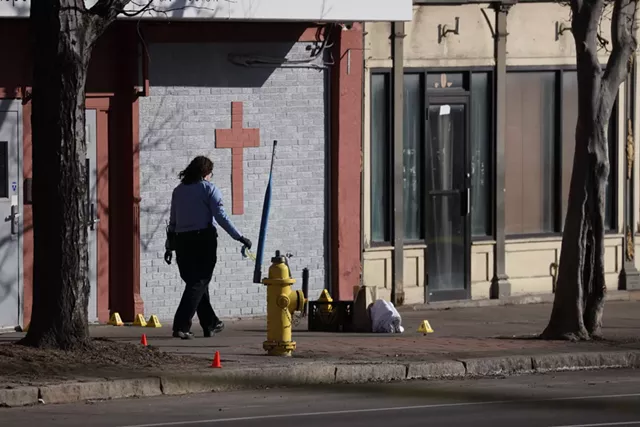 Rochester police examine an area outside of Open Door Mission where early Wednesday an officer shot a man who police said was brandishing a large knife. - PHOTO BY MAX SCHULTE