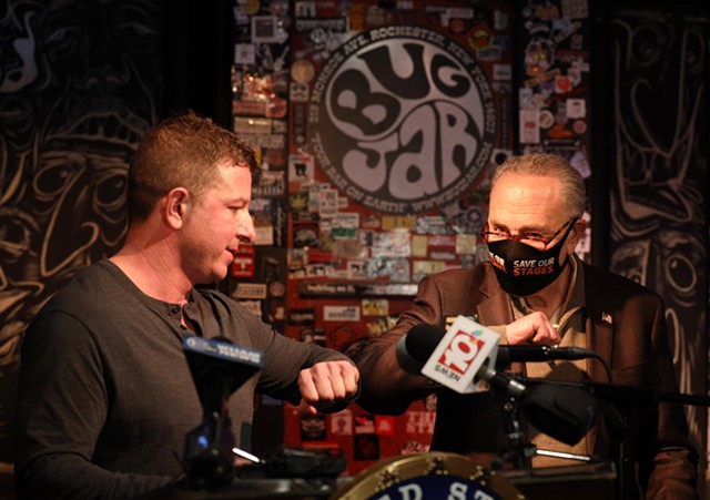 U.S. Sen. Chuck Schumer and Bug Jar co-owner Aaron Gibalski bump elbows at a March 31 news conference at the Bug Jar. - PHOTO BY MAX SCHULTE / WXXI NEWS