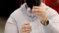 A staffer preps an injection of the COVID-19 vaccine. - PHOTO BY MAX SCHULTE / WXXI NEWS