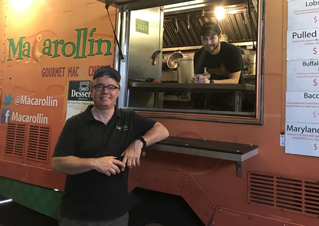 Chuck Andrews (left) and Tyler Schuber (right) of Macarollin' prepare for the Food Truck Rodeo at their warehouse. - PHOTO BY NOELLE E. C. EVANS