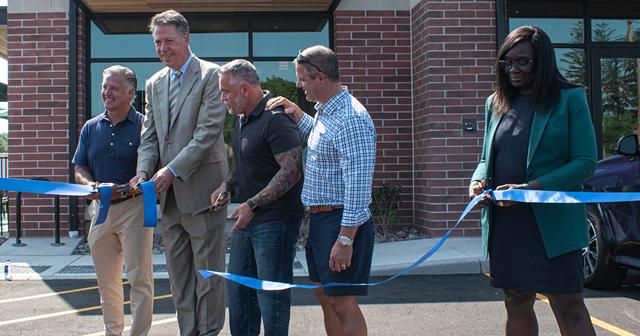 From right, Brighton Town Board member Robin Wilt, developer Danny Daniele, Starbucks store manager Ray Ballard, Brighton Supervisor Bill Moehle, developer Anthony Daniele, cut the ribbon on the opening of the Starbucks in the soon-to-be Whole Foods Plaza. - PHOTO BY JACOB WALSH