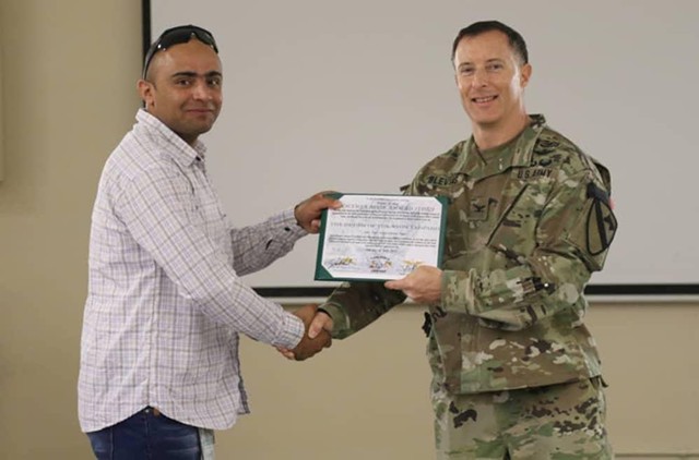 A U.S. Army soldier presents Noor Sediqi with an Award of Appreciation. - PHOTO PROVIDED BY NOOR SEDIQI