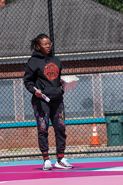 Artist and Peculiar Asphalt facilitator Brittany Williams created the program with the City of Rochester in order to improve the look of well-worn city basketball courts. - PHOTO BY RYAN WILLIAMSON