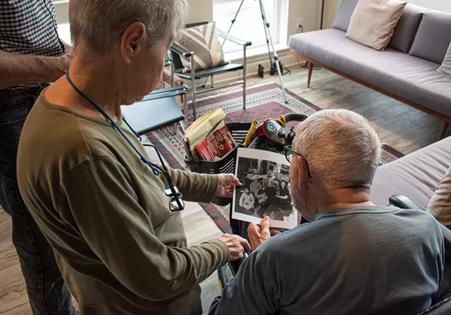 The Towlers reminisce over a photo of a former CITY newsroom staff. - PHOTO BY JACOB WALSH