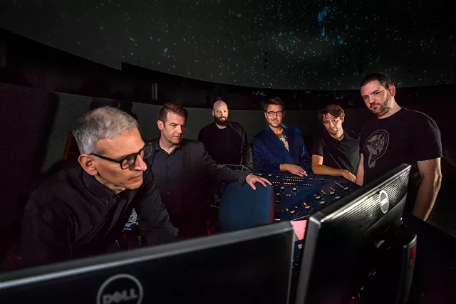 Steve Fentress shows the Digistar software to keyboardist Ian Sherman, bassist Sean Conlon, guitarist Miles McHugh, drummer Tommy Mintel, and audio engineer Matt Ramerman. - PHOTO BY DAVE JONES