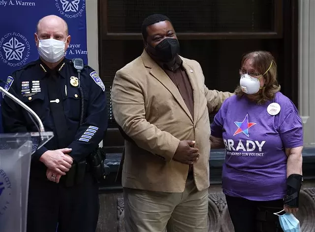 Rochester Interim Police Chief David Smith, City Councilmember Willie Lightfoot, and Kathy Richardson, a gun-violence prevention advocate, celebrate the signing of an agreement with the Brady Center to Prevent Gun Violence on Nov. 30, 2021. - PHOTO BY MAX SCHULTE
