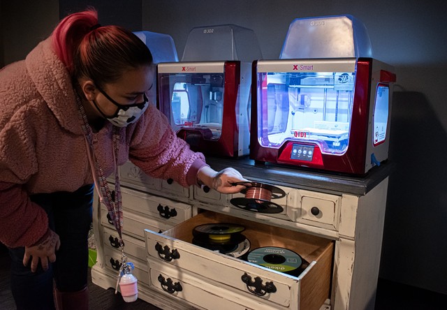 The technology center has three 3D printers and instructors who know how to use them. Chasiddy Matos shows how it's done. - PHOTO BY JACOB WALSH