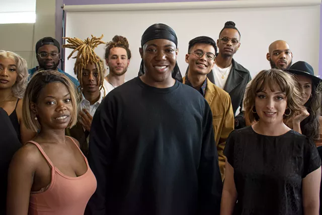 Adam Eaton, center, surrounded by members of Rochester Artist Collaborative, an organization he founded in 2019 to help artists of color find work. - PHOTO BY JACOB WALSH