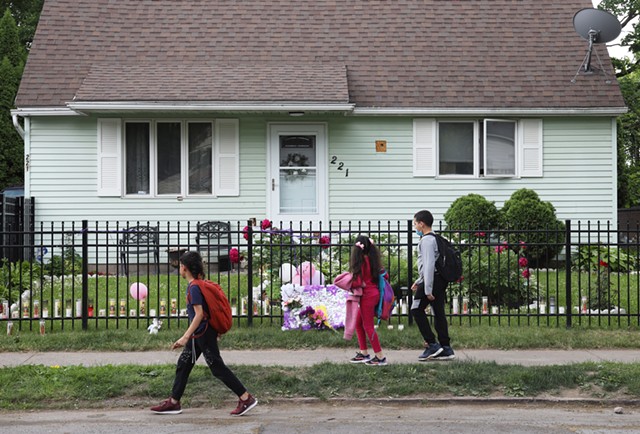A group of children walk past a house on 221 Emerson St. where 16-year-old Zahira Smith was shot while attending a birthday party. - PHOTO BY MAX SCHULTE