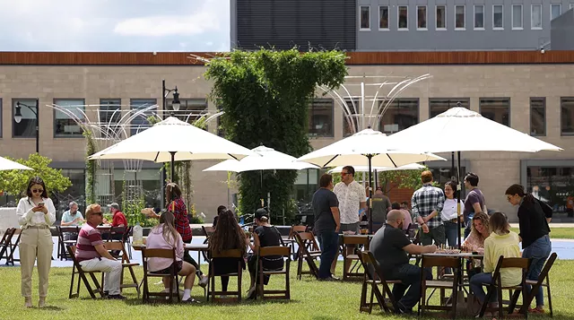 Parcel 5 was the site of the "Midday Bash," part of the Rochester Downtown Development Corp.'s "Downtown Definitely" campaign to draw people to the city's center with food trucks, music, lawn games, and fitness instructors. - PHOTO BY MAX SCHULTE