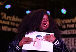 Danielle Ponder holds up her debut solo album, "Some of Us Are Brave," at an appearance at the Record Archive in Rochester, NY. - MAX SCHULTE/WXXI NEWS