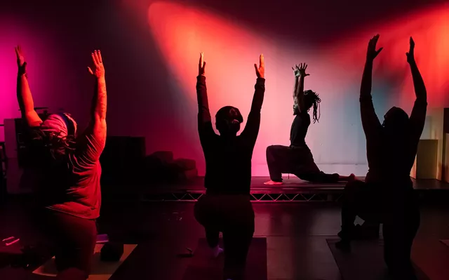 Poet and yoga instructor Anderson Allen leads participants during a "Scribe and Move" session. - PHOTO BY JACOB WALSH