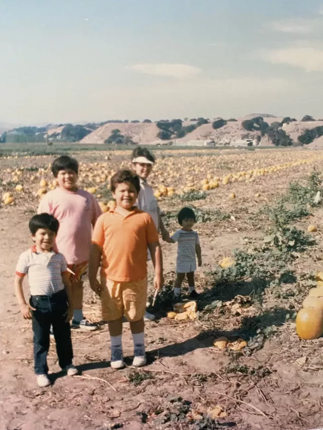 A young Carnegie Cellars Chef Steven Lara holds his mother's hand. His brothers are in the foreground. - PHOTO PROVIDED BY STEVEN LARA