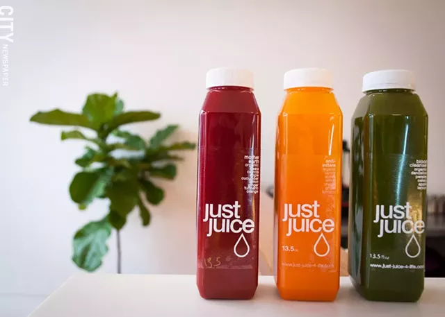 Fresh, bottled juices are stocked in the to-go cooler at Just Juice 4 Life. - PHOTO BY RYAN WILLIAMSON