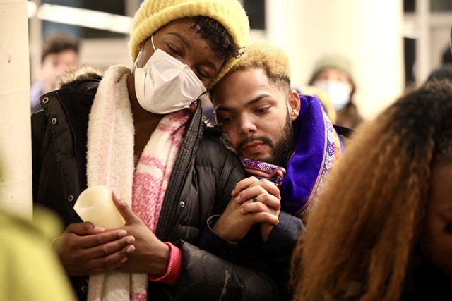 Vigil-goers Camille Uadiale (left) and Justin Delinois lean on each other during speeches lamenting Nichols's death. - PHOTO BY MAX SCHULTE
