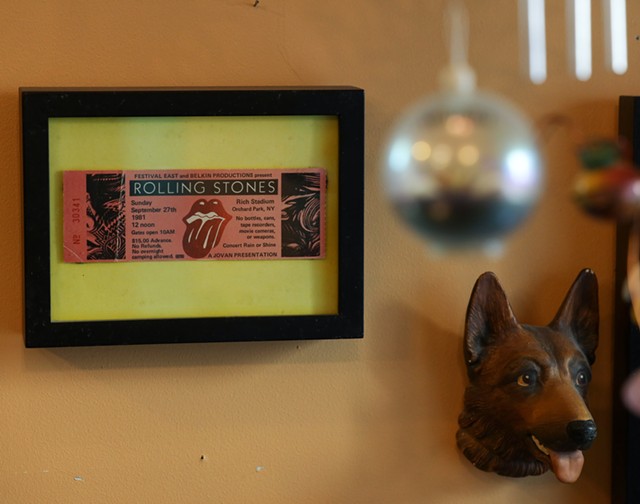 Among the tchotchkes and memories that adorn the South Wedge Barber Shop is a ticket to a Rolling Stones concert that the shop's late original owner, Gina Belardino, saw in 1981. - PHOTO BY MAX SCHULTE
