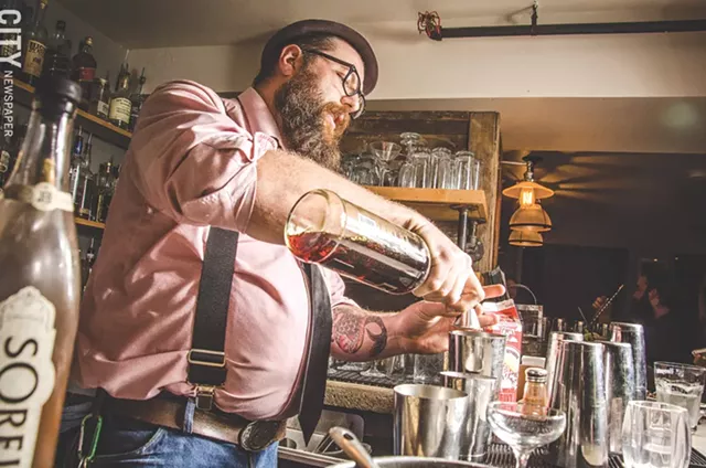 Bartender Jacob Rakovan mixes the "Cratchit's Comfort" at The Daily Refresher. - PHOTO BY MARK CHAMBERLIN