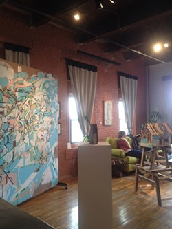 With its cozy features and cheerful vibe, visiting Makers feels like hanging out in a friend's apartment. At right: one of Nate Hodge's large paintings was recently displayed at the gallery. - PHOTO BY REBECCA RAFFERTY