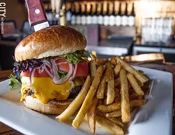 The Tavern at Gibbs's Tavern Burger on a brioche bun with Yukon gold potato fries. - PHOTO BY RENÉE HEININGER