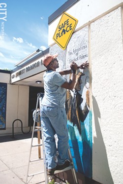 Richmond Futch Jr. recently created a set of literary murals on the façade of the Arnett Branch Library. - PHOTO BY RENÉE HEININGER