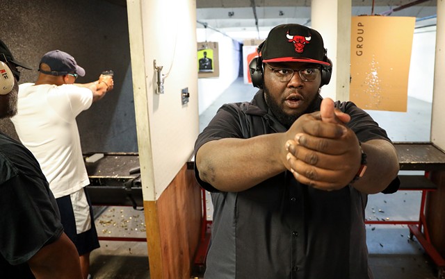 Paul Adell, a co-founder of the Rochester African American Firearms Association, demonstrates pistol grip technique at the at The Firing Pin gun range in Bergen.