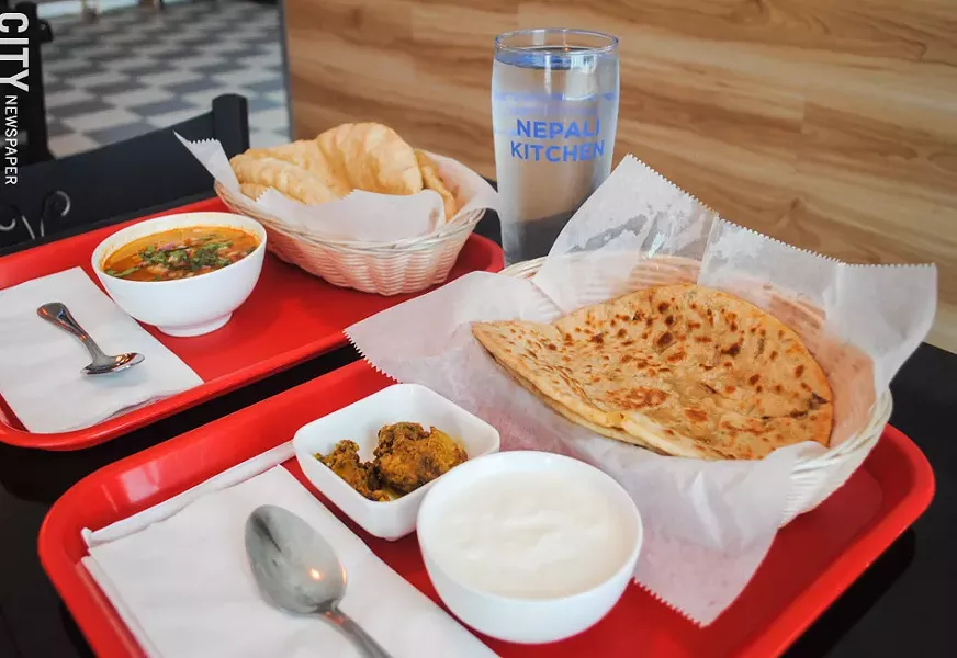 Aloo paratha (near) is a flatbread stuffed with seasoned potatoes, on the menu at Nepali Kitchen. - PHOTO BY JACOB WALSH