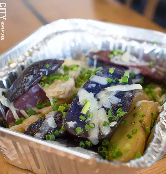 Tri-color fingerling potatoes with freshly-grated Parmesan, garlic, and chives. - PHOTO BY JACOB WALSH