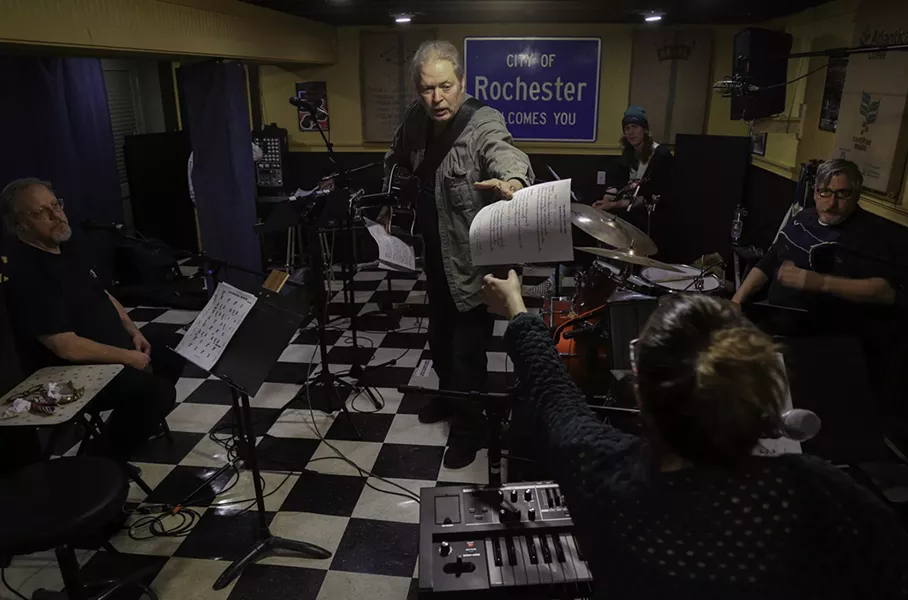Jeff Riales (standing) shares his version of "No One Will Ever Know" with the house band for this year's "If all Rochester Wrote the Same song" concert. - PHOTO BY MAX SCHULTE