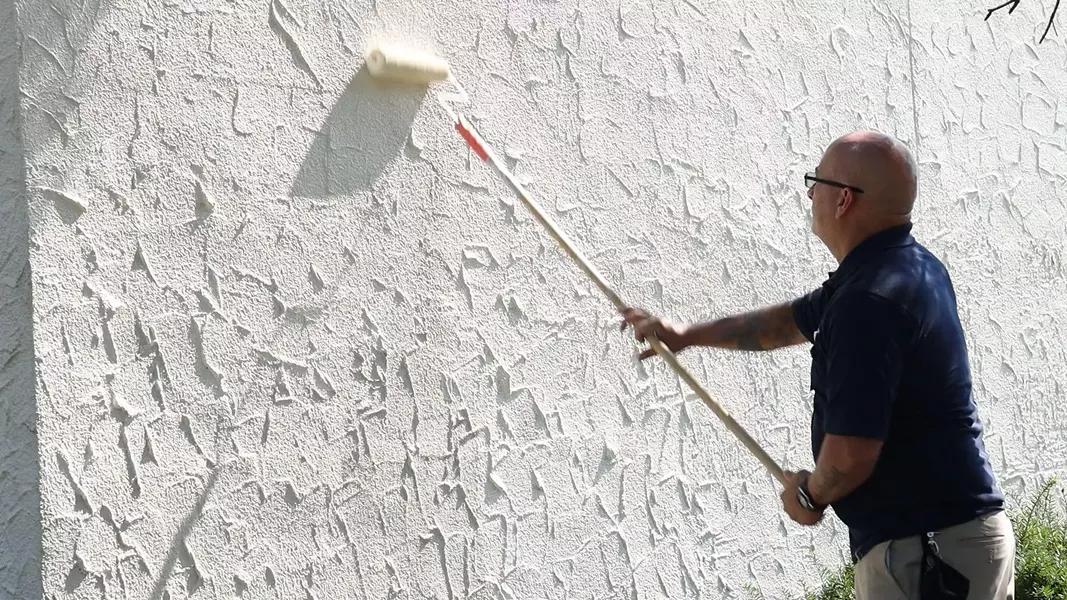 Workers remove hateful graffiti at the Pines of Perinton apartment complex on Thursday. - PHOTO CREDIT MAX SCHULTE, WXXI NEWS