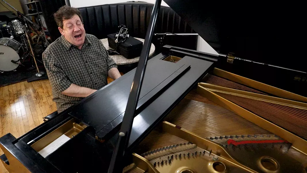 Seiger plays trumpet and piano and sings like Louis Armstrong. "I hope ... I can keep just a little bit of the joy he wanted to give the world," he says. - PHOTO BY MAX SCHULTE / WXXI NEWS