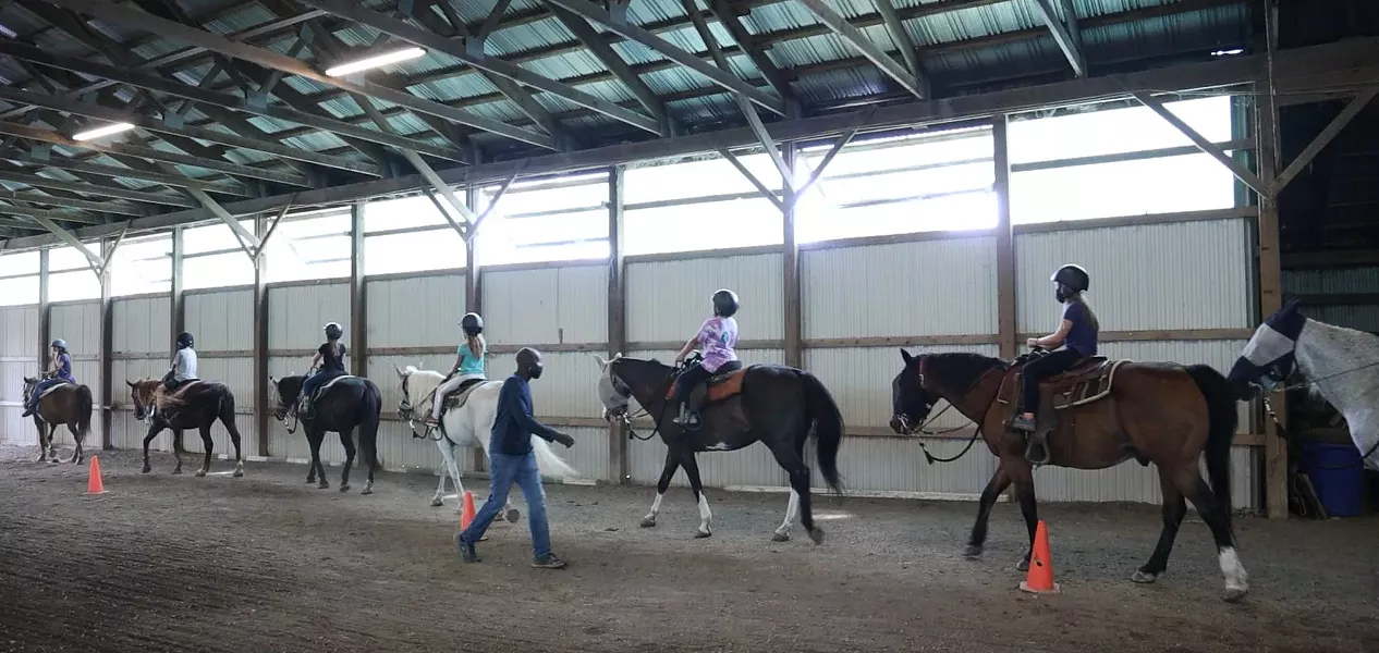 The program at A Horse's Friend teaches feeding, maintenance — and, of course, riding the gentle beasts. - PHOTO CREDIT MAX SCHULTE / WXXI NEWS
