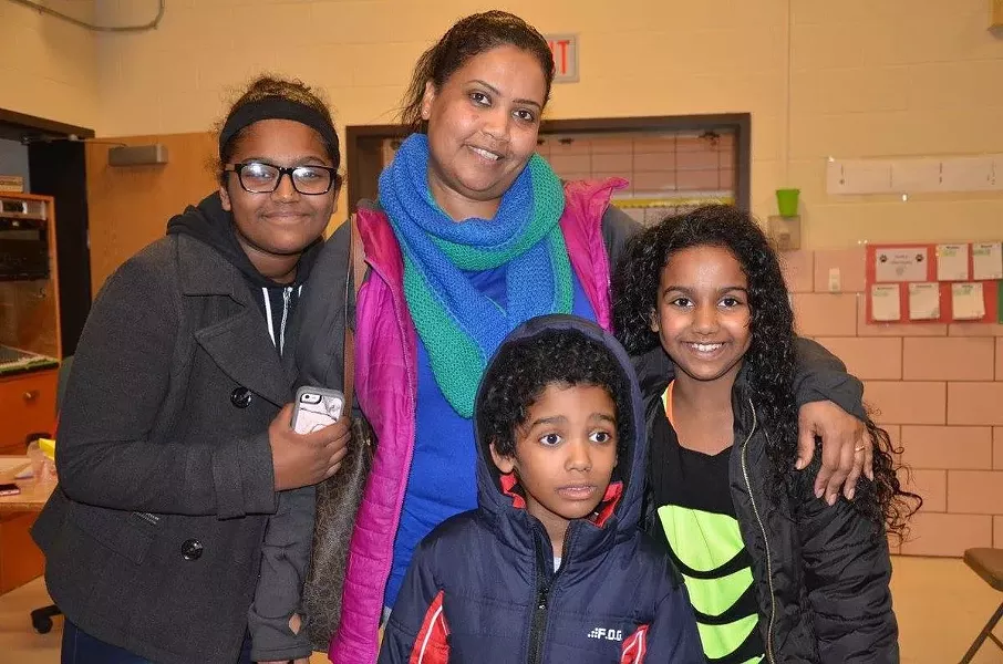Mai Abdullah, center, and her three children. - PHOTO PROVIDED