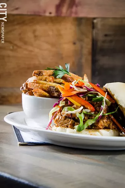pulled pork BBQ sandwich with house BBQ sauce and vinegary vegetable slaw. - PHOTO BY MARK CHAMBERLIN