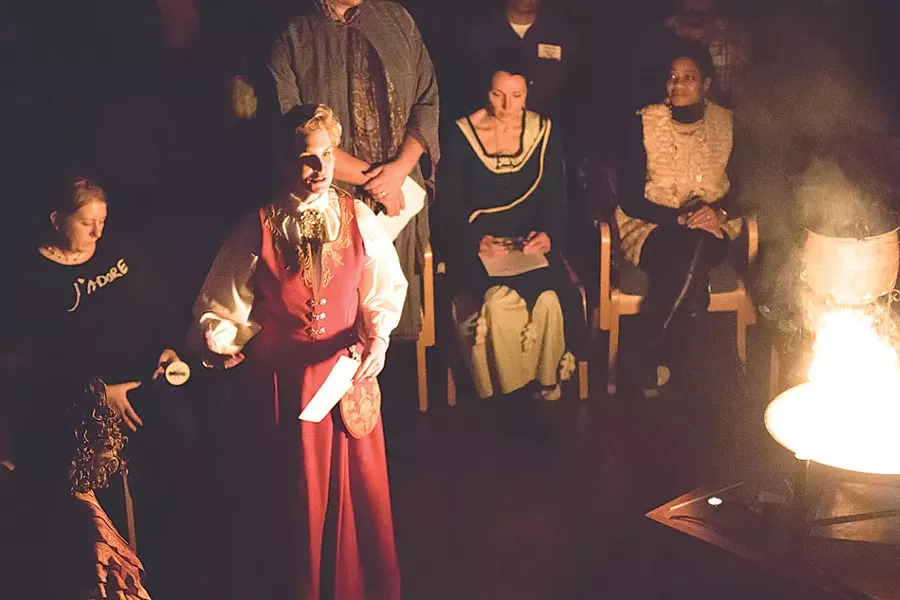 First Unitarian Church Senior Minister Kaaren Anderson leads a "howl" during the 2014 winter - solstice celebration. - PHOTO BY DAVE BURNET