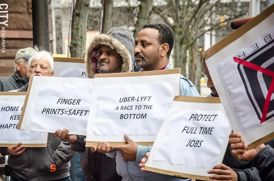 Local cab drivers rallied against Uber at City Hall last month. - PHOTO BY MARK CHAMBERLIN