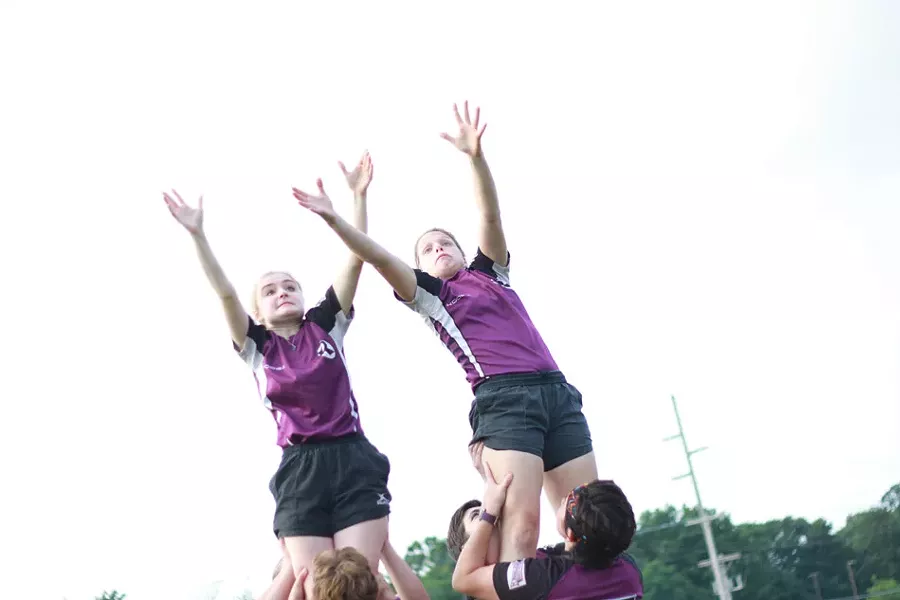 Members of the Rochester Renegades rugby team lift up two players to fight over an incoming ball during a recent practice. - PHOTO BY KEVIN FULLER