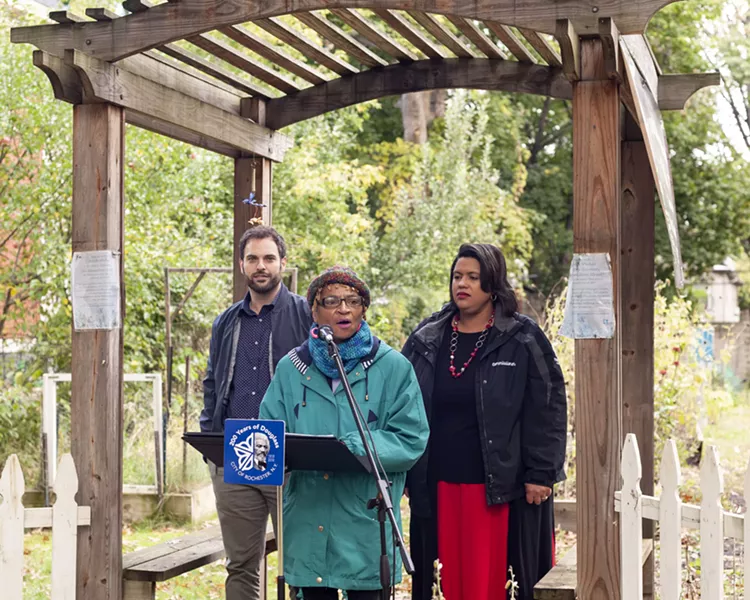 Ann Culbreth, co-manager of the South Wedge Victory Gardens, talks about the benefits of longer-term permits for community gardens. With her is City Council member Mitch Gruber, left, and City Department of Recreation and Youth Services Commissioner Daniele Lyman-Torres, right. - PHOTO BY JEREMY MOULE