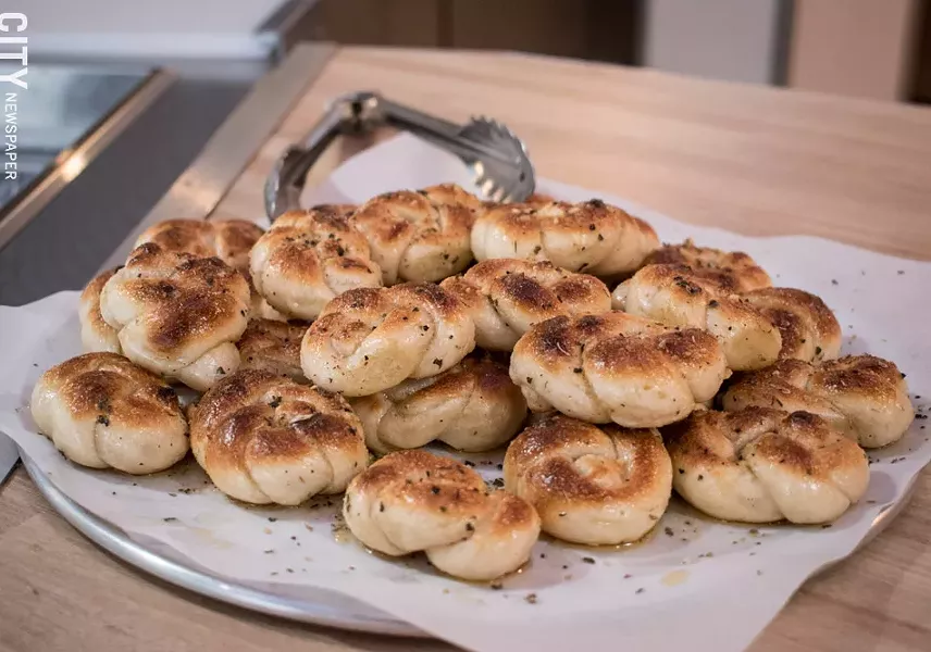 Chef Katelyn Dunne makes each batch of dough for pizza crusts and garlic knots in-house (pictured). - PHOTO BY JACOB WALSH