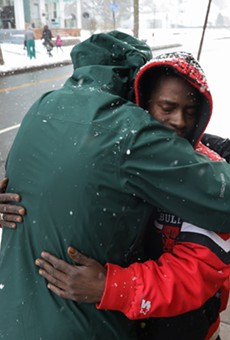 Julius Greer Sr., right, accepts a hug from Ed Knauf, a deacon whose ministry prays for the city's homicide victims at the sites where they were killed. Greer's son, Julius Greer Jr., was 14 when he was shot and killed on Jan. 2, 2022.