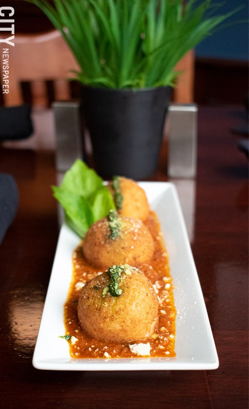 For starters: the four cheese arancini topped with tomato sauce and pesto. - PHOTO BY JACOB WALSH