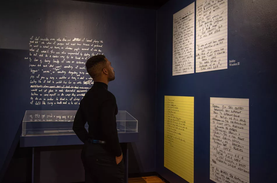 Artist Joshua Rashaad McFadden with his installation, "Evidence," at Visual Studies Workshop. - PHOTO BY SARI OISTER
