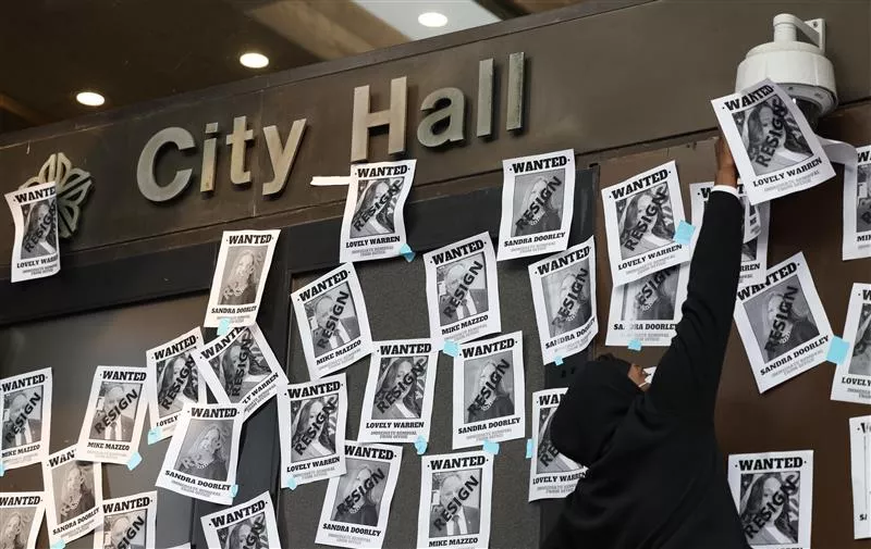 During a protest at City Hall Tuesday, demonstrators hung flyers demanding that Mayor Lovely Warren and District Attorney Sandra Doorley resign. - PHOTO BY MAX SCHULTE