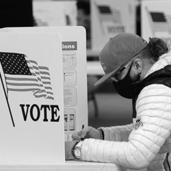 A voter fills in his ballot during a previous year's election. - FILE PHOTO