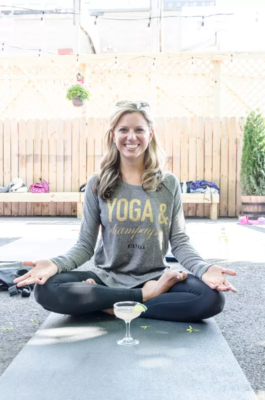 Nicole Kazimer just wanted to combine her two favorite things, yoga and champagne, for her line of clothes, but ended up hosting classes. - PHOTO BY MARK CHAMBERLIN