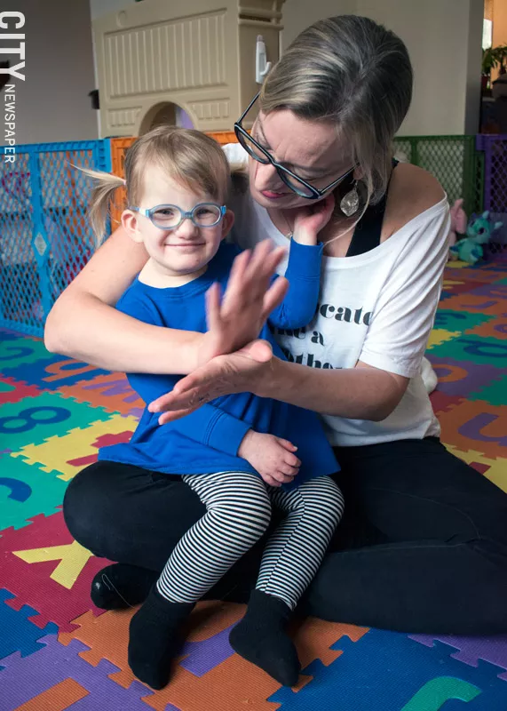 Vivian Dooher doesn't communicate verbally, so she and her mother talk using ASL. - PHOTO BY RENÉE HEININGER