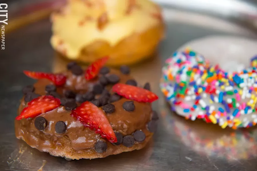 Vanilla rainbow, chocolate covered strawberry and peaches, apricot, and cream donuts at The Red Fern. - PHOTO BY THOMAS J. DOOLEY